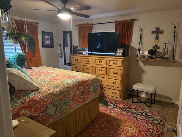 bedroom featuring baseboards and ceiling fan