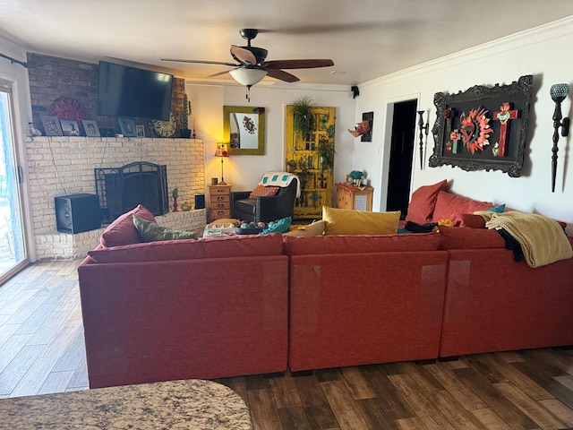 living area with ornamental molding, dark wood-style floors, a wealth of natural light, and ceiling fan