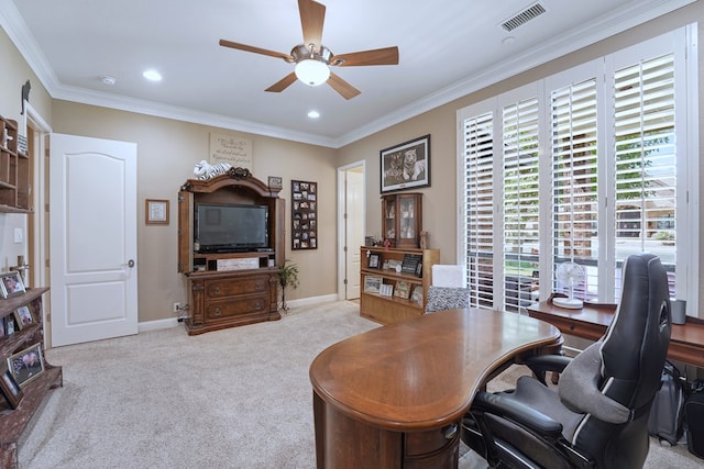 carpeted office space featuring ceiling fan, plenty of natural light, and ornamental molding