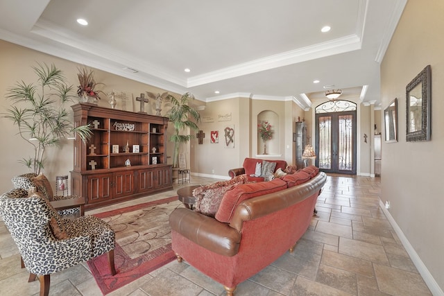 living room with a tray ceiling, crown molding, and french doors