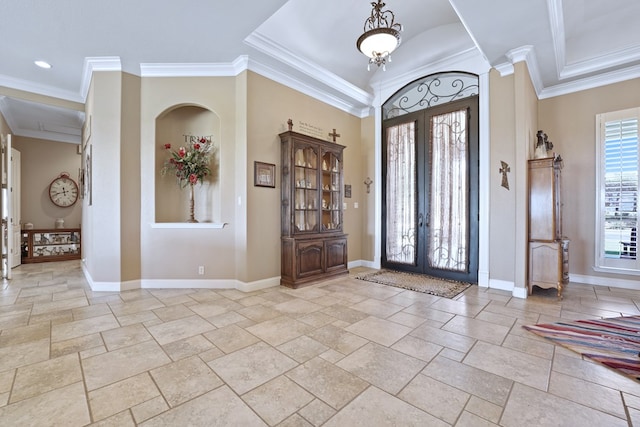 foyer featuring crown molding and french doors