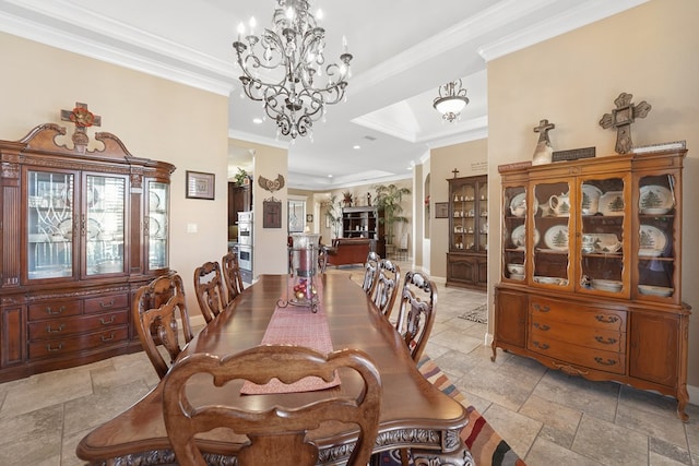 dining room featuring a raised ceiling and ornamental molding