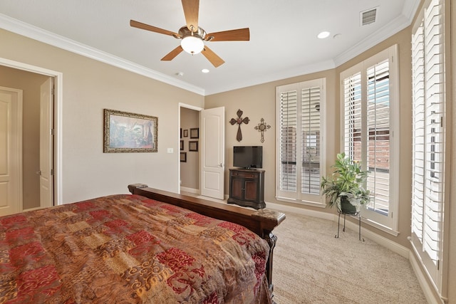 carpeted bedroom featuring ceiling fan and crown molding