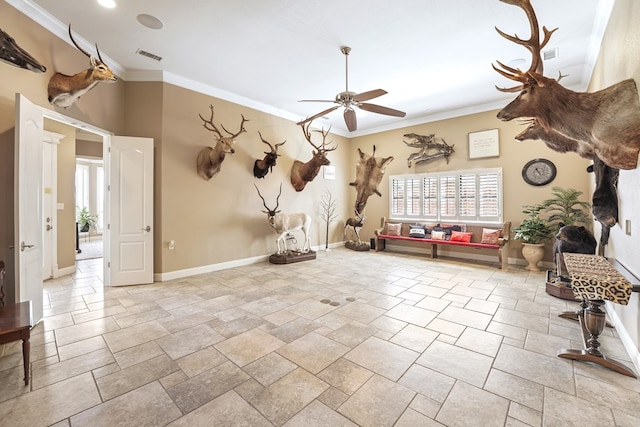 interior space featuring ceiling fan and crown molding