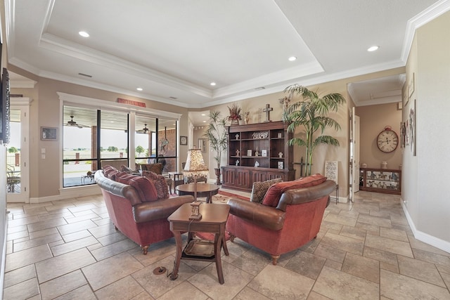 living room with a tray ceiling, ceiling fan, and ornamental molding