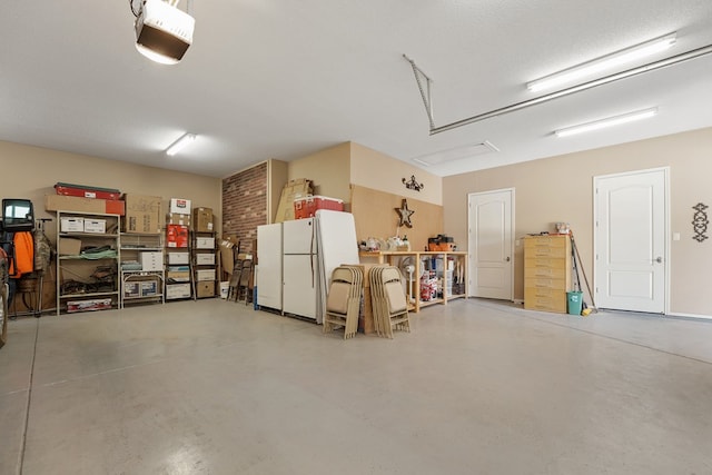 garage with white fridge and a garage door opener