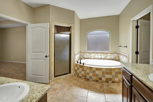 bathroom featuring a bath, a stall shower, and vanity