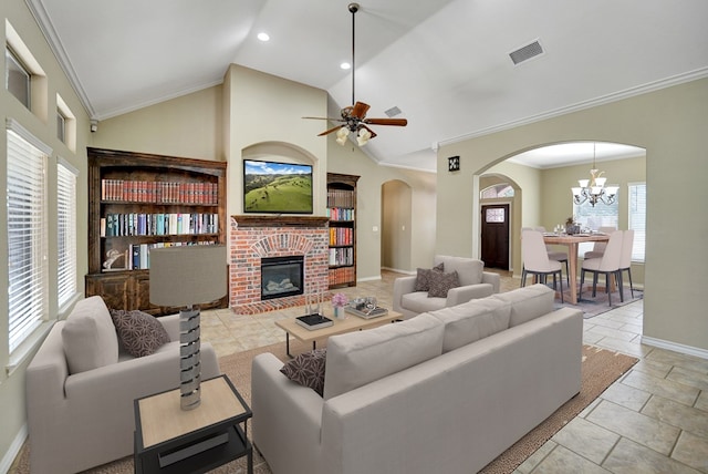 living room with visible vents, a fireplace, arched walkways, crown molding, and ceiling fan with notable chandelier