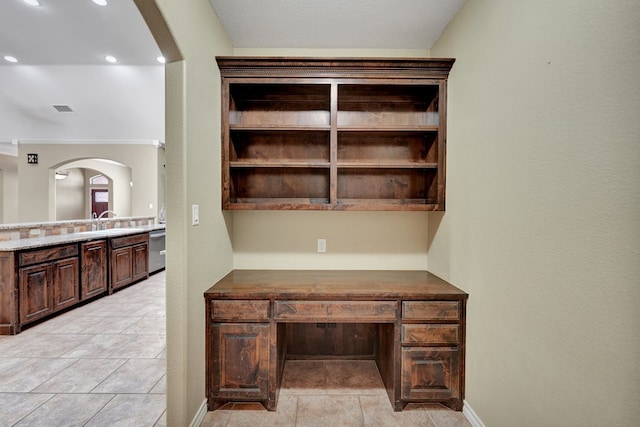 office area featuring baseboards, visible vents, arched walkways, and a sink