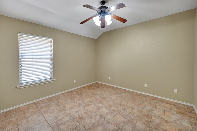 spare room featuring light tile patterned floors, baseboards, and ceiling fan