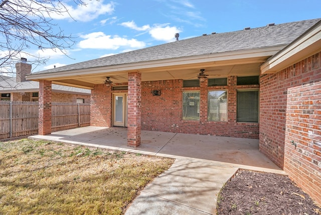 rear view of house with a patio area, brick siding, a ceiling fan, and fence