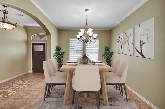 dining room with visible vents, arched walkways, crown molding, baseboards, and a chandelier