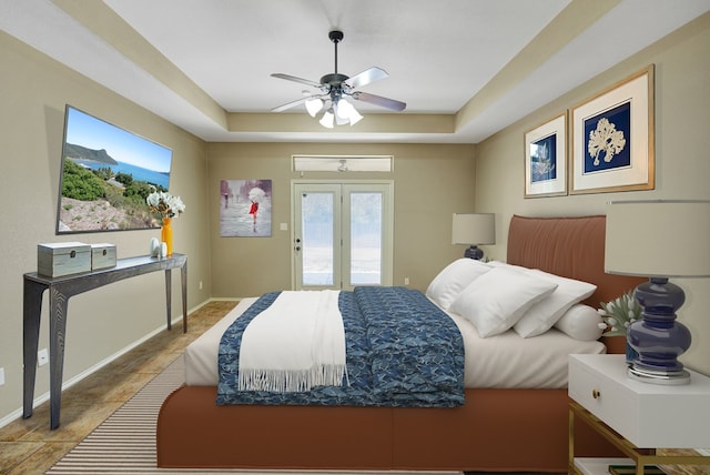 bedroom with baseboards, a tray ceiling, french doors, a ceiling fan, and access to outside