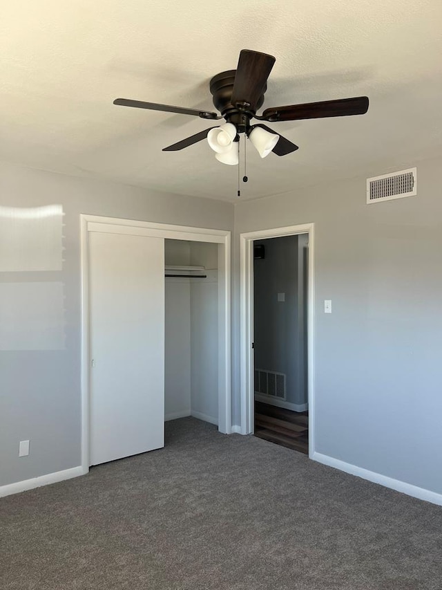 unfurnished bedroom with baseboards, a closet, visible vents, and carpet flooring