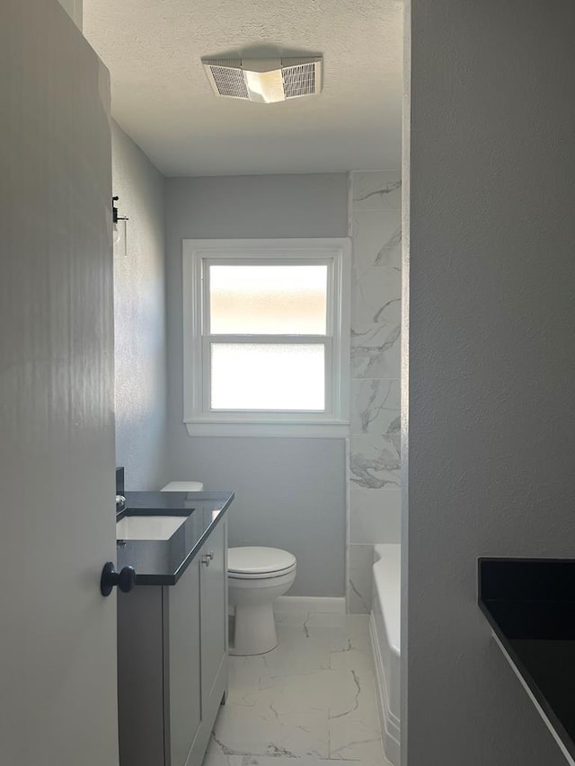 bathroom with marble finish floor, visible vents, toilet, vanity, and a textured ceiling