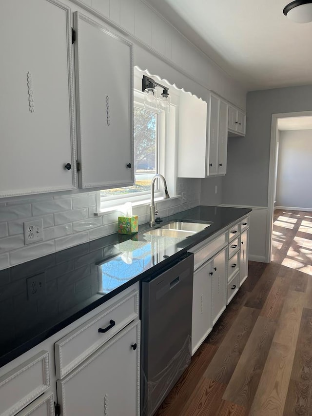 kitchen with a sink, white cabinetry, decorative backsplash, and stainless steel dishwasher