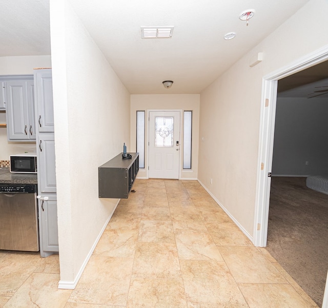 foyer featuring light colored carpet