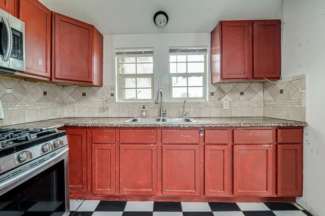 3608 S County Rd 1195, Midland, TX 79706 - kitchen featuring appliances with stainless steel finishes, a sink, dark brown cabinets, and tile patterned floors