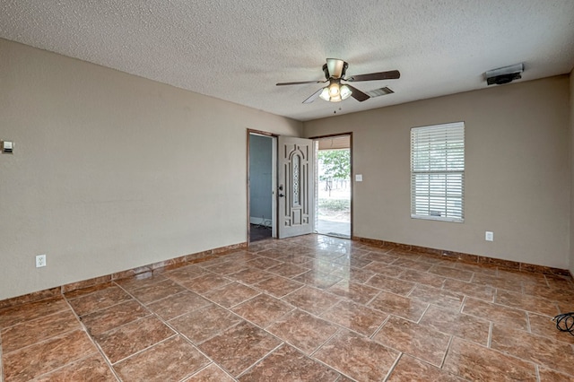 3608 S County Rd 1195, Midland, TX 79706 - spare room featuring a ceiling fan, a textured ceiling, and baseboards