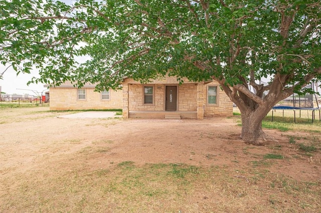 3608 S County Rd 1195, Midland, TX 79706 - view of front of house with a trampoline, stone siding, and fence