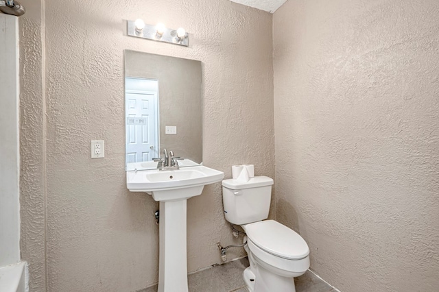 3608 S County Rd 1195, Midland, TX 79706 - half bathroom featuring toilet and a textured wall