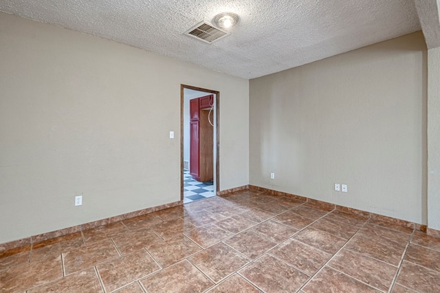 3608 S County Rd 1195, Midland, TX 79706 - empty room featuring a textured ceiling and baseboards
