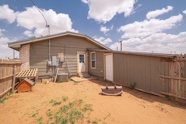3608 S County Rd 1195, Midland, TX 79706 - rear view of house featuring fence, entry steps, and central AC
