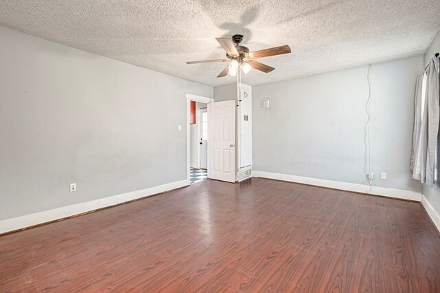 3608 S County Rd 1195, Midland, TX 79706 - empty room with ceiling fan, dark wood-style flooring, baseboards, and a textured ceiling