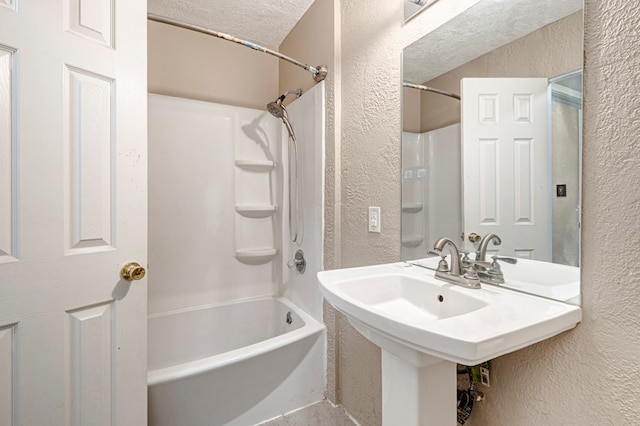 3608 S County Rd 1195, Midland, TX 79706 - full bath featuring a textured wall, a sink,  shower combination, and a textured ceiling