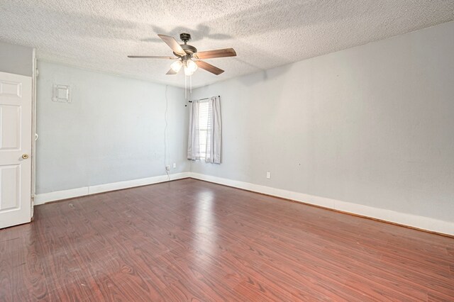 3608 S County Rd 1195, Midland, TX 79706 - unfurnished room with dark wood-type flooring, ceiling fan, baseboards, and a textured ceiling
