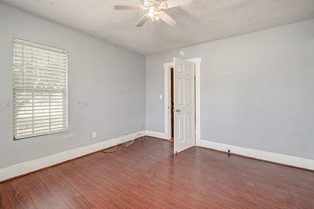 3608 S County Rd 1195, Midland, TX 79706 - empty room featuring a ceiling fan, wood finished floors, a textured ceiling, and baseboards
