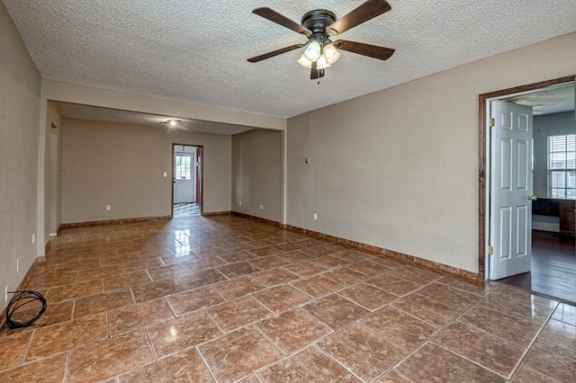 3608 S County Rd 1195, Midland, TX 79706 - empty room with ceiling fan, a textured ceiling, and baseboards