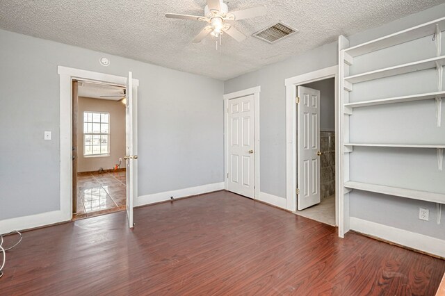 3608 S County Rd 1195, Midland, TX 79706 - unfurnished bedroom featuring wood finished floors, a textured ceiling, baseboards, and a ceiling fan