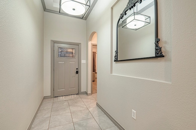 doorway with light tile patterned flooring