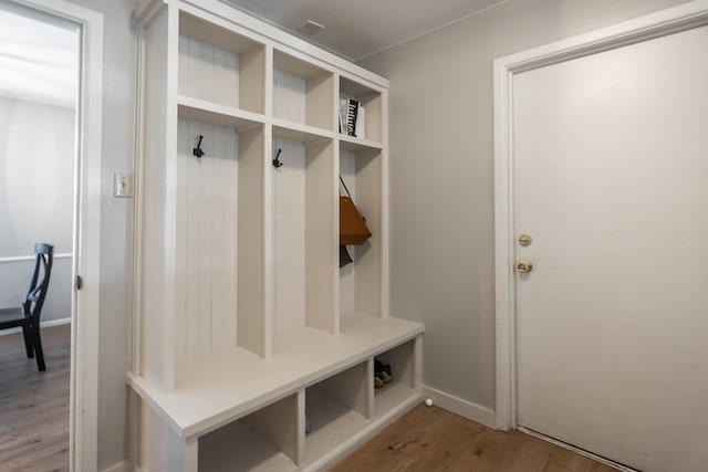 mudroom with baseboards, wood finished floors, and visible vents