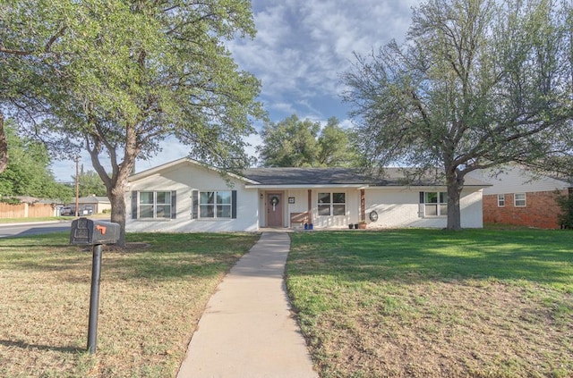 ranch-style home with a porch and a front lawn