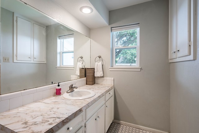 bathroom featuring baseboards and vanity
