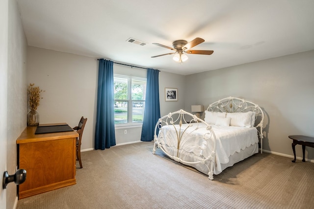 carpeted bedroom with baseboards, a ceiling fan, and visible vents