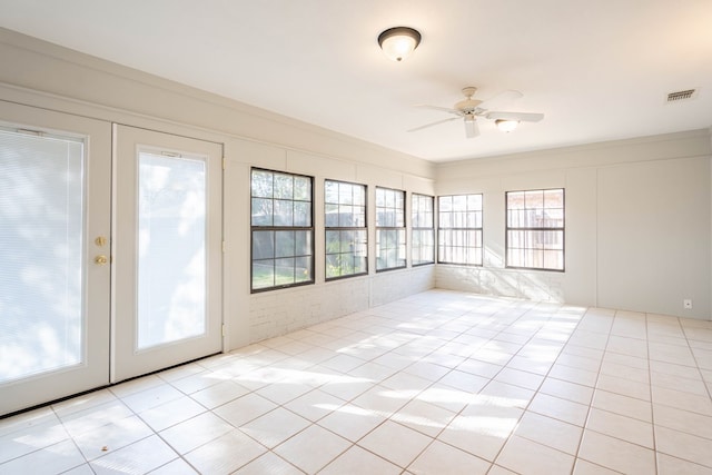 unfurnished sunroom with visible vents and ceiling fan