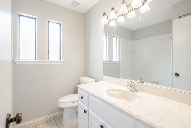 bathroom with a healthy amount of sunlight, visible vents, toilet, and tile patterned floors