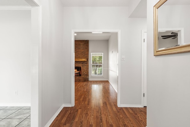 hallway featuring hardwood / wood-style floors and crown molding