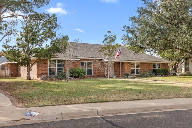 ranch-style home featuring a front yard