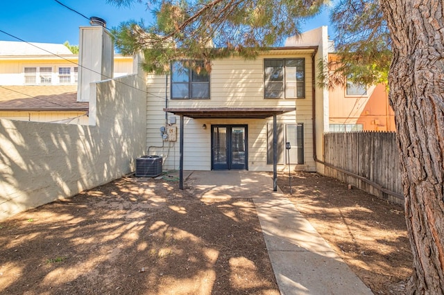 back of property with french doors, a patio, and central AC unit