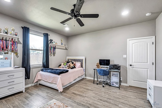6811 W County Rd 41, Midland, TX 79707 - bedroom with light wood finished floors, baseboards, recessed lighting, and ceiling fan