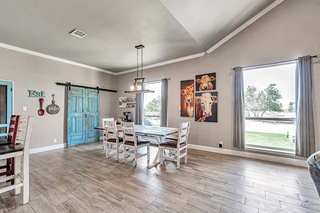 6811 W County Rd 41, Midland, TX 79707 - dining area with a barn door, baseboards, ornamental molding, a chandelier, and light wood-type flooring