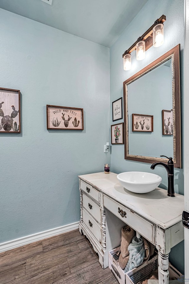 6811 W County Rd 41, Midland, TX 79707 - bathroom featuring vanity, wood finished floors, and baseboards