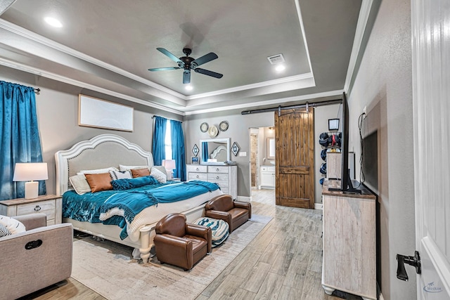6811 W County Rd 41, Midland, TX 79707 - bedroom featuring a barn door, wood finished floors, a raised ceiling, ornamental molding, and ceiling fan