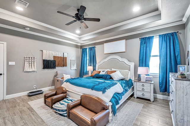 6811 W County Rd 41, Midland, TX 79707 - bedroom with a tray ceiling, ornamental molding, light wood-type flooring, baseboards, and recessed lighting
