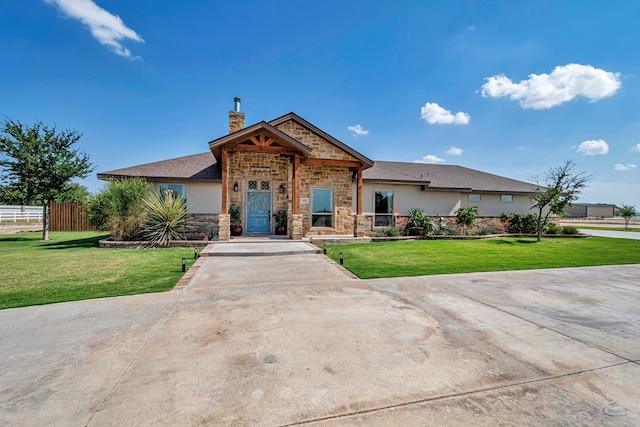 6811 W County Rd 41, Midland, TX 79707 - view of front facade with stone siding, a chimney, and stucco siding