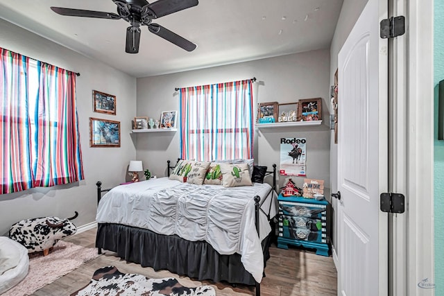 6811 W County Rd 41, Midland, TX 79707 - bedroom featuring wood finished floors, ceiling fan, and baseboards